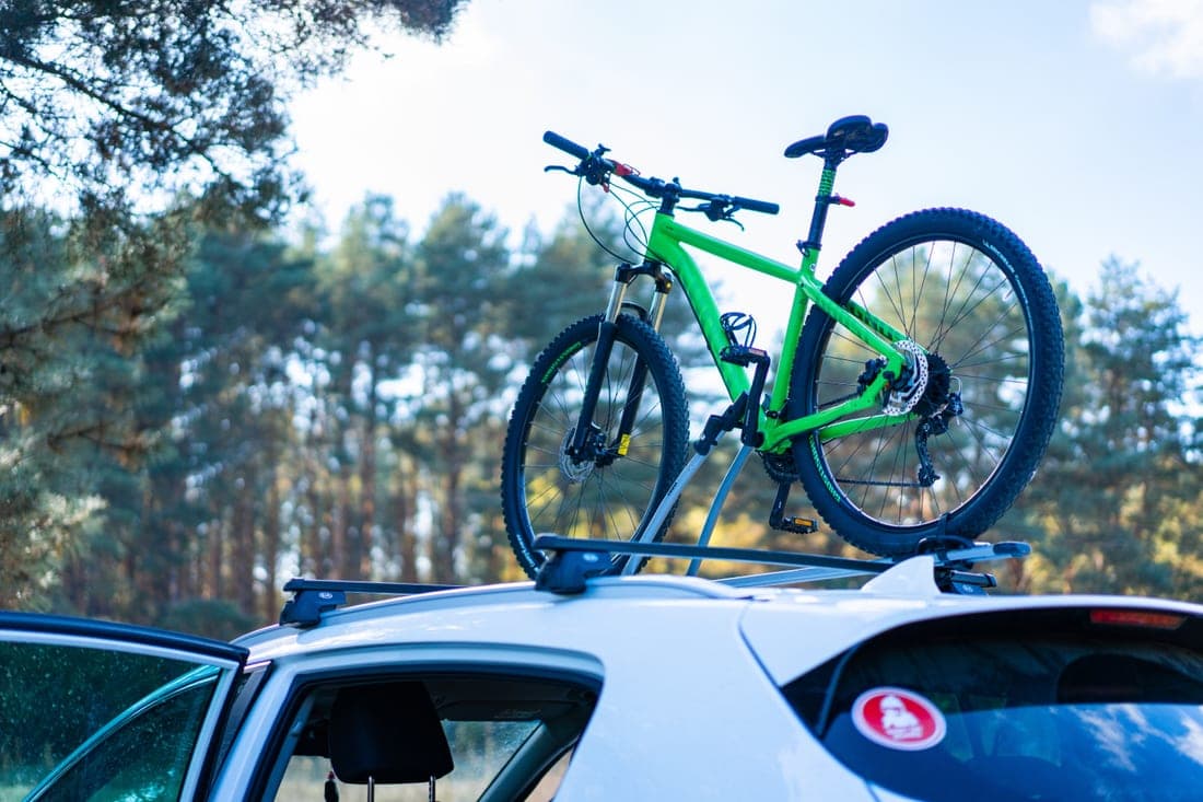 Two bicycles carried on a rear-mounted car bike rack