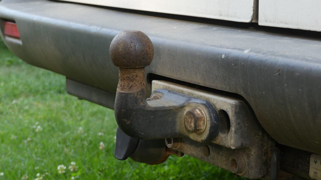 A steel cargo basket mounted in a vehicle's rear hitch receiver