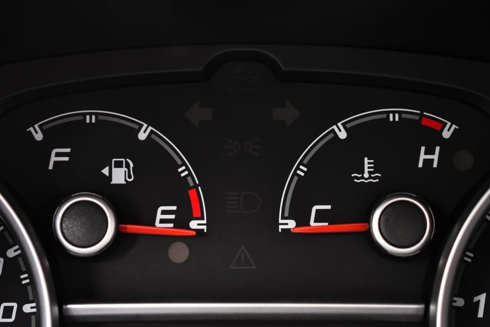 A car's fuel gauge and dashboard display viewed from the driver's seat